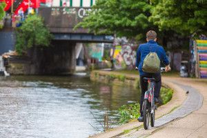 Boy cycling by canal
