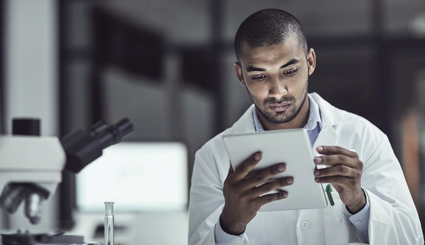 Shot of a scientist recording his findings on a digital tablet